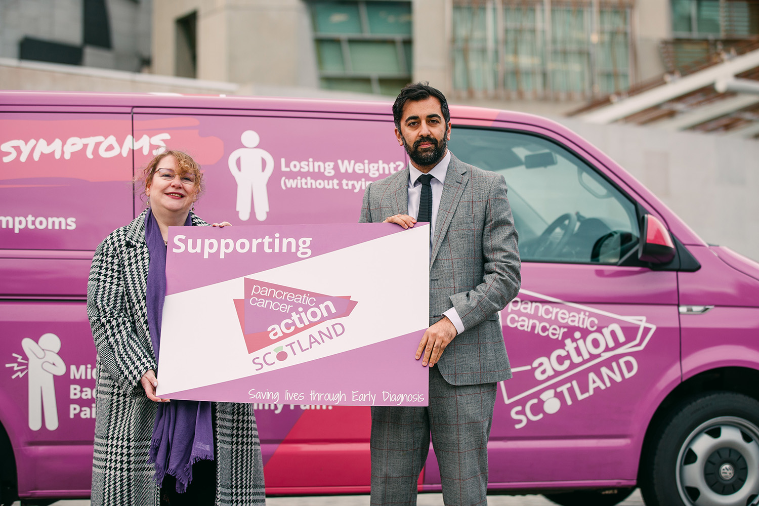 Humza Yousaf holding a PCAS sign.